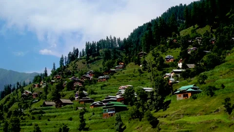 Slow motion shot of beautiful huts with lush green mountains in hilly area o Stock Footage 200746205