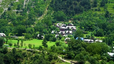 Slow motion shot of beautiful huts with lush green mountains in hilly area o Stock Footage 200746206