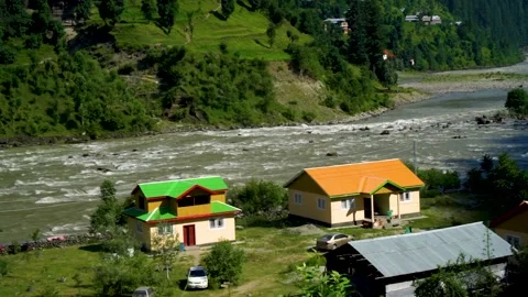Slow motion shot of beautiful huts with lush green mountains in hilly area o Stock Footage 200746253