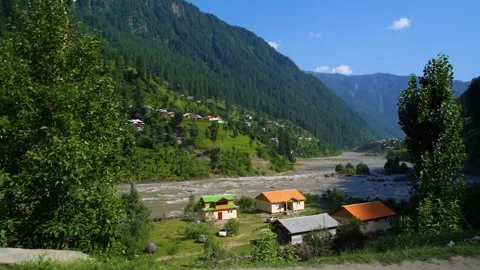 Slow motion shot of beautiful huts with lush green mountains in hilly area o Stock Footage 200746386