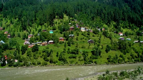 Slow motion shot of beautiful huts with lush green mountains in hilly area o Stock Footage 200746447