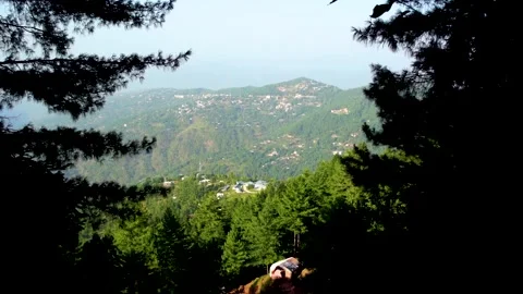 Slow motion shot of beautiful huts with lush green mountains in hilly area o Stock Footage 200746987