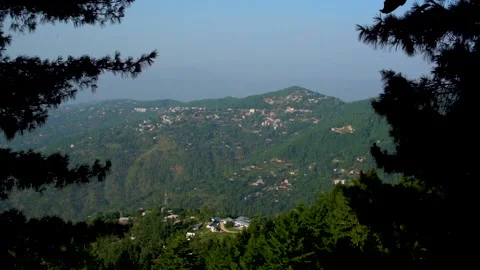 Slow motion shot of beautiful huts with lush green mountains in hilly area o Stock Footage 200747370