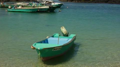 A slow motion shot of a boating floating on very clear waters Stock Footage 74548622
