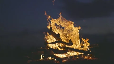 Slow motion shot of bonfire over dark blue sky background. Orange flames Stock Footage 252282671