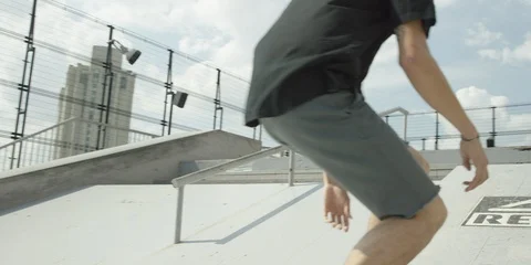 Slow motion shot of boy doing tricks on skateboard on ramps in city, Tokyo Stock Footage 136113459
