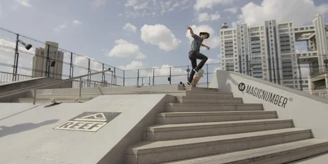 Slow motion shot of boy doing tricks on skateboard on ramps in city, Tokyo Stock Footage 136114132