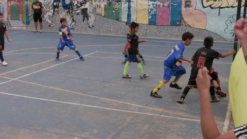 Slow motion shot of a boy kicking a goal while playing football Stock Footage 278859778