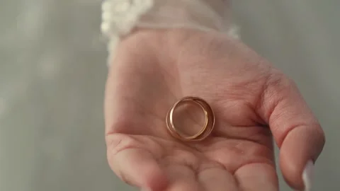 Slow motion shot of Bride in wedding dress holding rings in hands, closeup Stock Footage 243661987