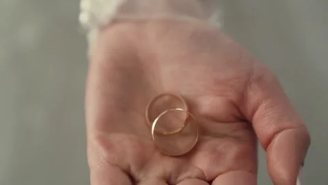Slow motion shot of Bride in wedding dress holding rings in hands, closeup Stock Footage 244171114