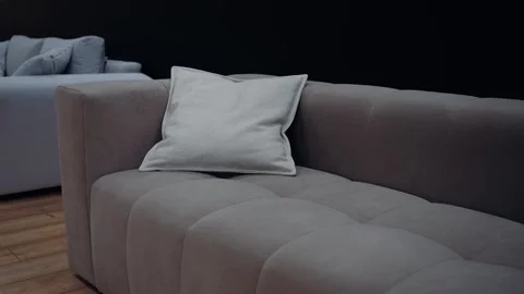 Slow motion shot of a brown couch with medium sized beige cushions. 4k video. Stock Footage 232056317