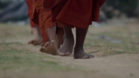 Slow Motion Shot Of Buddhist Monks Wearing Saffron Robes While Walking Barefoot Stock Footage 134426285