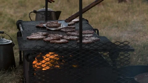 Slow motion shot of bugers being grilled Stock Footage 116996516