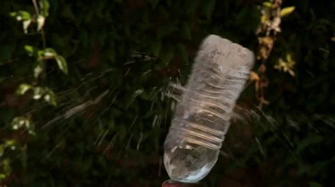 Slow motion shot bullet hit water bottle dramatic drought Intense outdoors  Stock Footage 11408415