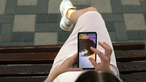 Slow motion shot. In a bustling public place, a pregnant young woman sits on a Stock Footage 249415433