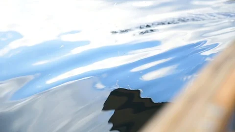 Slow Motion Shot of Canoe Paddle Dipping into Smooth Lake Surface Stock Footage 124445871