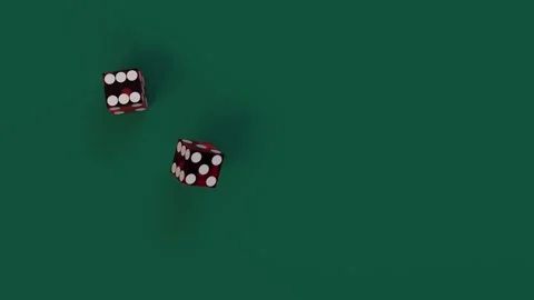 A slow-motion shot captures two red dice rolling across a green game table Stockbeeldmateriaal 285503342
