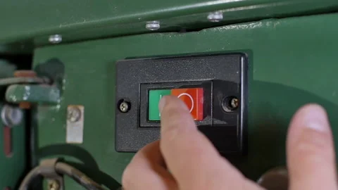 Slow motion shot of carpenter pushing the ON button of his drill power tool. Video stock 140977194