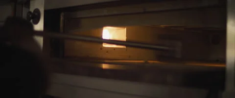 Slow motion shot of a chef cleaning a pizza oven. Stock Footage 147518233