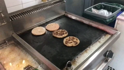Slow Motion Shot of Chef Cooking and Flipping Burgers on Grill Stock Footage 92182679