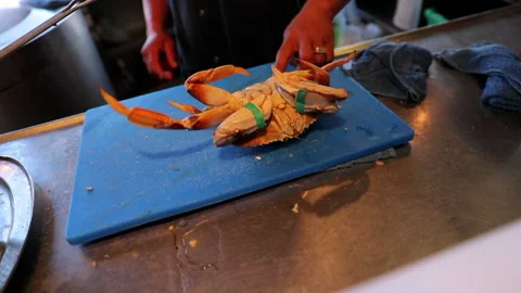 Slow Motion Shot Of Chef With Crab On Blue Cutting Board At Store - San Stock Footage 229983074