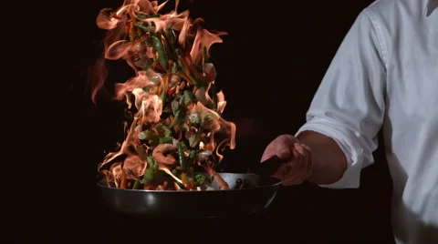 Slow motion shot of chef with flaming stir fry; shot on Phantom Flex 4K at 1000 Stock Footage