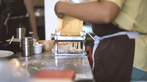 Slow motion shot of chef making pasta from hand pasta machine Stock Footage 101416283