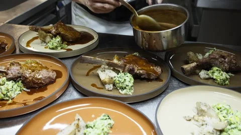 Slow Motion Shot of Chef Spreading Sauce on Steak in Fine Dining Kitchen Stock Footage 245880231