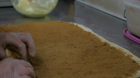 Slow motion shot of cinnamon roll dough being rolled Stock-Footage 93376562