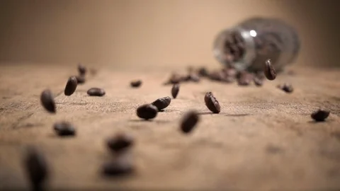 Slow Motion Shot Close Up Coffee Beans Falling on Wood Base and Bouncing. Stock Footage 104357136
