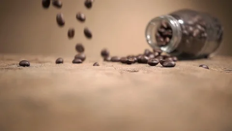 Slow Motion Shot Close Up Coffee Beans Falling on Wood Base and Bouncing. Stock Footage 104358589
