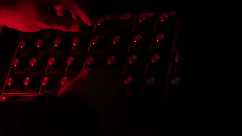Slow motion shot, close up, man turnig knobs on vintage synth during live 動画素材 147237426