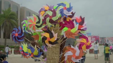 Slow motion shot of colourful wind mill Stock Footage 241157360