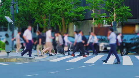 Slow motion shot of commuters walking on a crosswalk in Marunouchi Tokyo Stock Footage 344322807