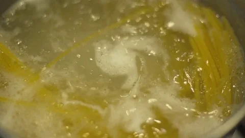 Slow motion shot of cooking spaghetti in a pot Stock Footage 84768097