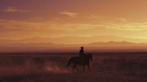 Slow motion shot of a cowboy riding a horse Stock Footage