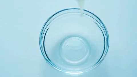 Slow motion shot cracking an egg in half into bowl in slow motion Stock Footage 126835667