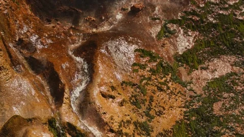 Slow motion shot of a crystal-clear mountain waterfall cascading down a wet, Stock Footage 347653230