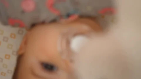 Slow motion shot of cute tiny baby girl lying in her crib Stock Footage 106159887