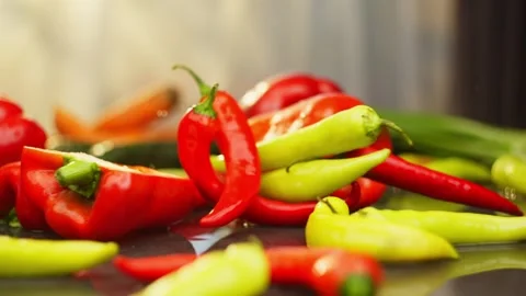 Slow motion shot of different varieties of hot peppers falling Video stock 296362222