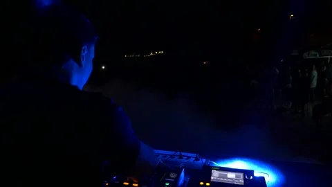 Slow motion shot of a dj playing in front of a crowd at a party Stock Footage 188146456