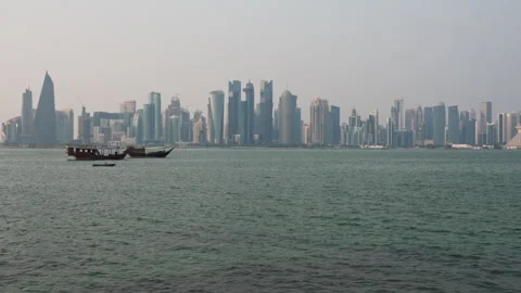Slow Motion Shot of Doha Skyline and Traditional Dhow Boats at Daytime in Qatar. Stock Footage 336722109