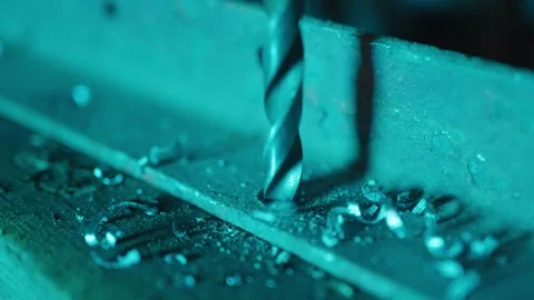 Slow motion shot of drill drilling a piece of metal Stock Footage 175181715