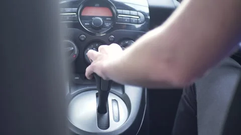 Slow motion shot of driver's hand pulling lever gearbox handbrake in car Stock Footage 276505015