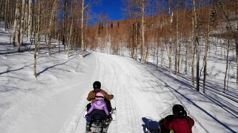 Slow motion shot as drone traces family on motor sleds on the road Stock-Footage 108538260