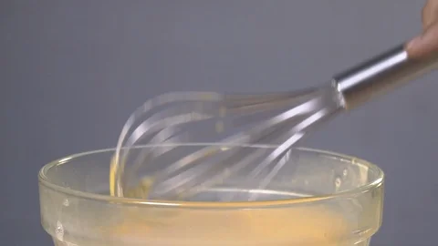 Slow Motion Shot of Egg Whisking in a Bowl Stock Footage