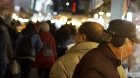 Slow motion shot of elderly man eating food at South Korean Market, Seoul 스톡 동영상 84756879