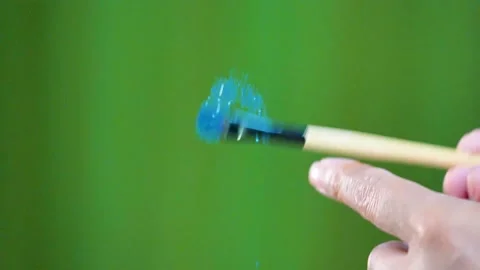 Slow motion shot of falling glitter colour from brush big close up Stock Footage 199279160