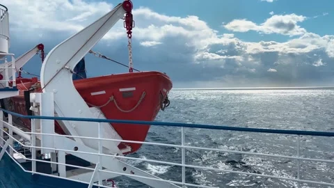 A slow-motion shot featuring a lifeboat on a ferry sailing through rough se.. Stock Footage 285929338