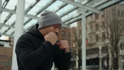 Slow motion shot of a fighter shadowboxing in the city Video stock 153339582
